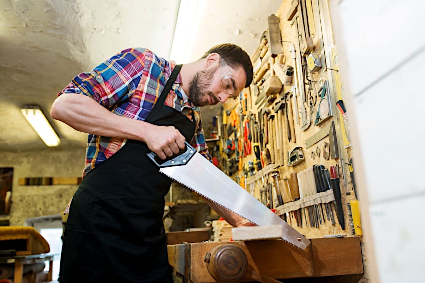 Using Handsaw at Workbench